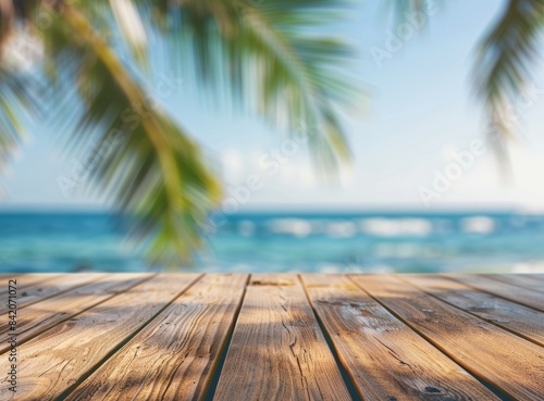 Empty wooden table top with blurred background of blue sea and palm trees on a summer beach for product display presentation mockup