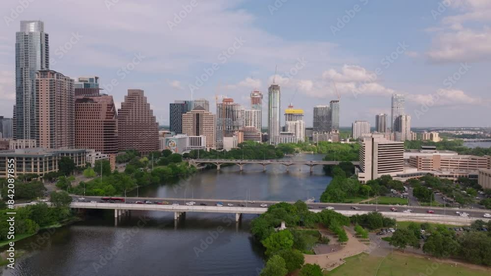 Aerial view of downtown Austin, Texas in a sunny day, featuring the iconic skyline, Colorado River, lush greenery, and bridges Aerial view of downtown Austin, Texas in a sunny day, featuring the iconic skyline, Colorado River, lush greenery, and bridges