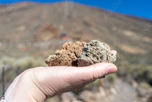 Volcano Stones in Hand, Volcanic Pumice with Glass, Pieces of Lava, Basalt Extrusive Igneous Rock photo