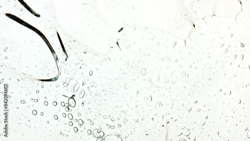 Bubble cluster, cells under a microscope. Transparent cosmetic gel fluid with molecule bubbles oil distribution. Macro Shot of Natural Organic Cosmetics, Medicine. Production Close-up. Slow Motion. 4k