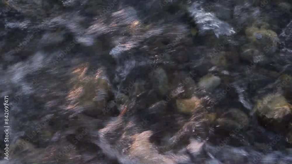 water flowing into the pebbles water flowing into the pebbles