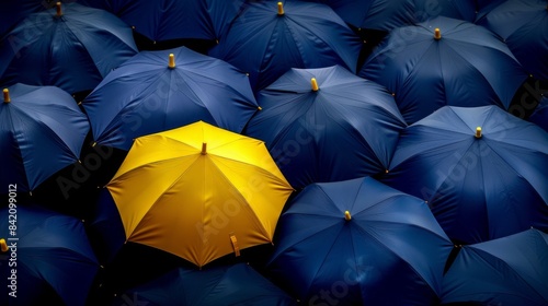 concept for leadership with many blue and yellow umbrella