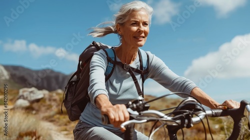 Senior Woman Enjoying a Cycling Adventure in Nature © Oksana Smyshliaeva