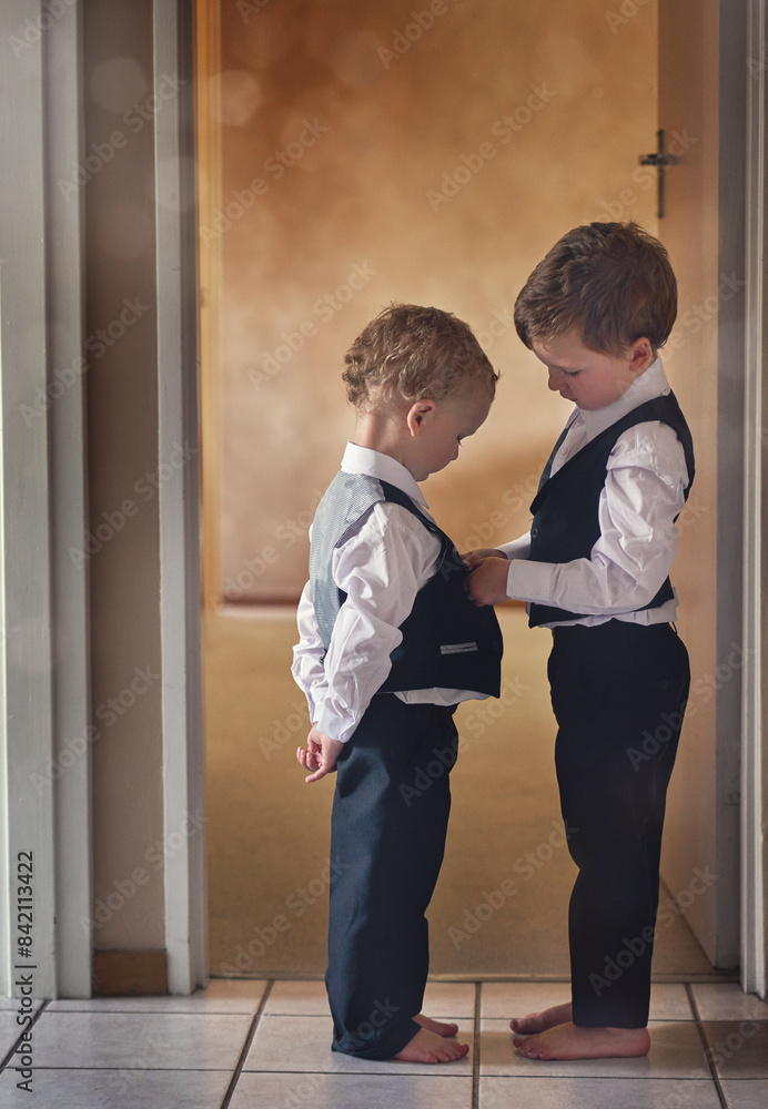 Brothers, helping and children get ready in home for support, celebration and together for event. Family, suit and connection in apartment for wedding, anniversary and young boy with care or love Brothers, helping and children get ready in home for support, celebration and together for event. Family, suit and connection in apartment for wedding, anniversary and young boy with care or love