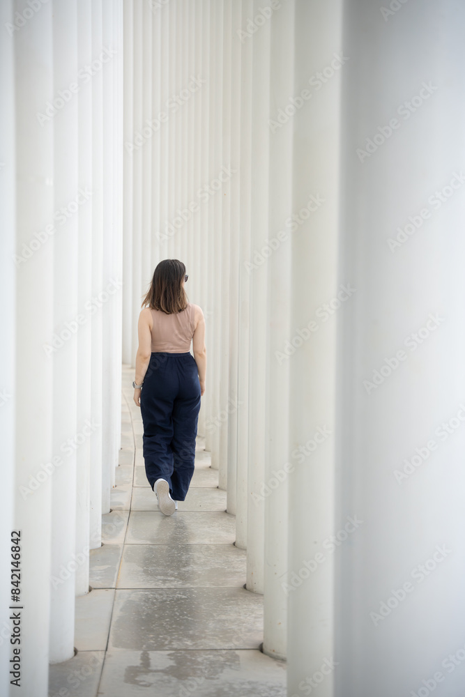 person sitting between columns person sitting between columns