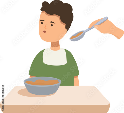 Young boy is refusing to eat dinner while sitting at the table, an adult is trying to feed him