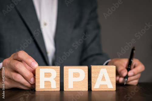 There is wood cube with the word RPA. It is an abbreviation for Robotic Process Automation as eye-catching image.