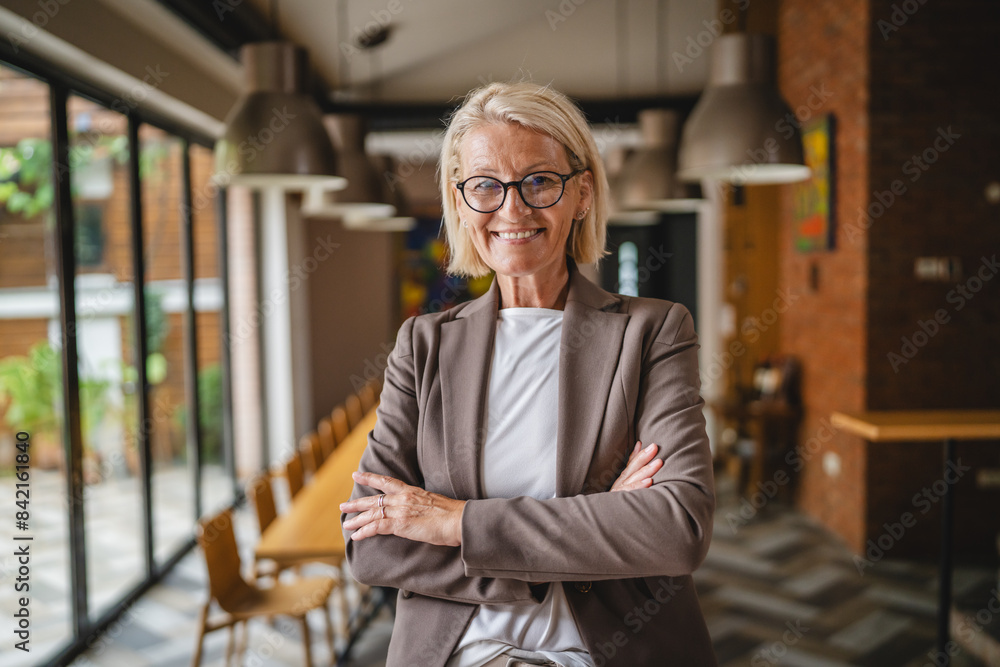 Portrait of mature senior woman at work stand and smile in the winery Portrait of mature senior woman at work stand and smile in the winery
