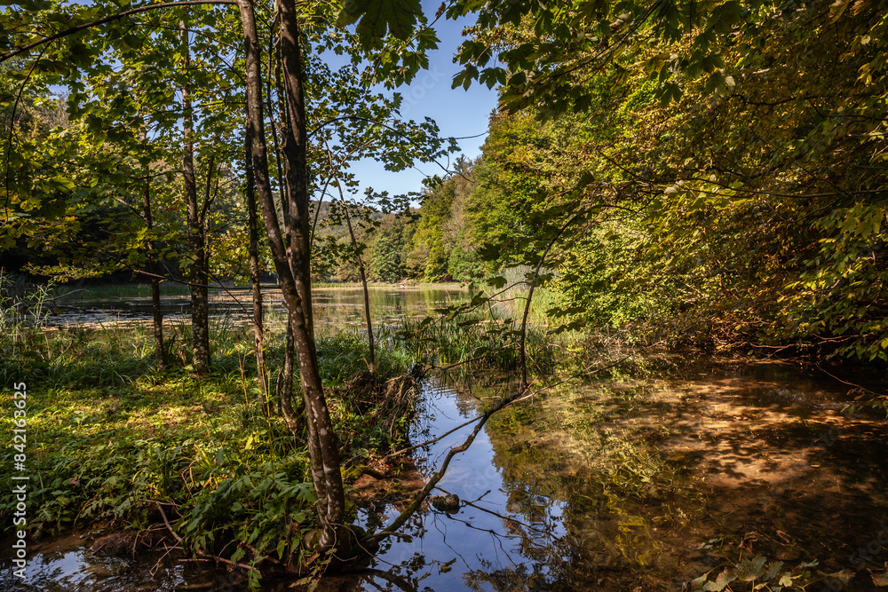 Panorama of the pond Jankovac, a small water lake surrounded by trees and forest in the Papuk mountain, a major national park of Croatia, in the Slavonia region.