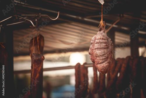 Serbian Sremski Kulen Kobasica sausage, handmade, hanging and drying in the coutryside of Serbia. Kulen is a traditional pork sausage, dry and cured, from Croatia and Serbia, from region of Srem. photo