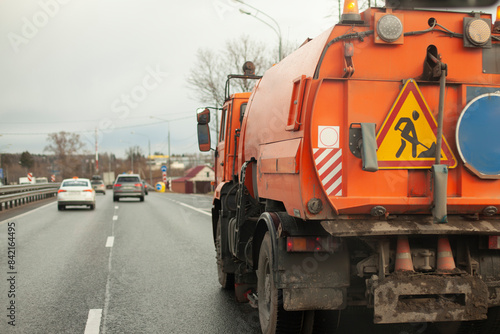 Harvesting equipment. Special transport for cleaning in the city. Orange truck.