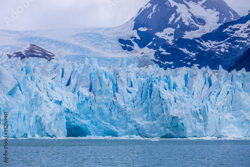 Blu ice glacier Perito Moreno in Patagonia, Argentina. Huge ice seracs wall above the lake on a cloudy nasty day. South America Arcitc landscape on polar latitude. Mountain glacier scenic landscape