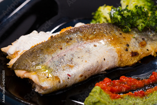 Delicious fried brook trout fillets with broccoli and tartare saucee photo