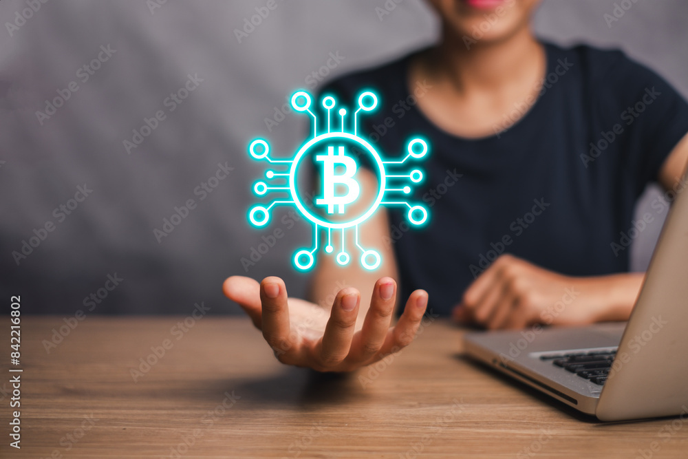 Bitcoin concept, Woman hand holding bitcoin on virtual screen, Bitcoin Cryptocurrency Digital Bit Coin BTC Currency Technology Business Internet Concept. Bitcoin concept, Woman hand holding bitcoin on virtual screen, Bitcoin Cryptocurrency Digital Bit Coin BTC Currency Technology Business Internet Concept.