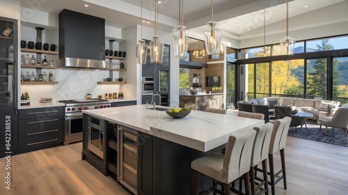 Open-concept kitchen featuring a large island with a built-in wine fridge, pendant lighting