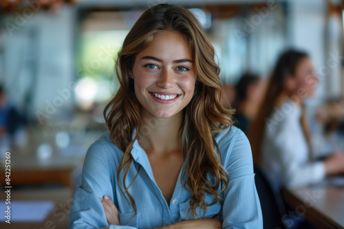 Brunette businesswoman in blue formal shirt, arms crossed in meeting room