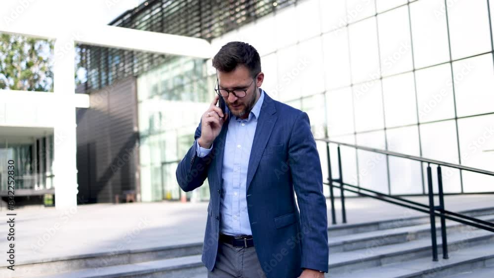 Young businessman telephoning on his way from work Young businessman telephoning on his way from work