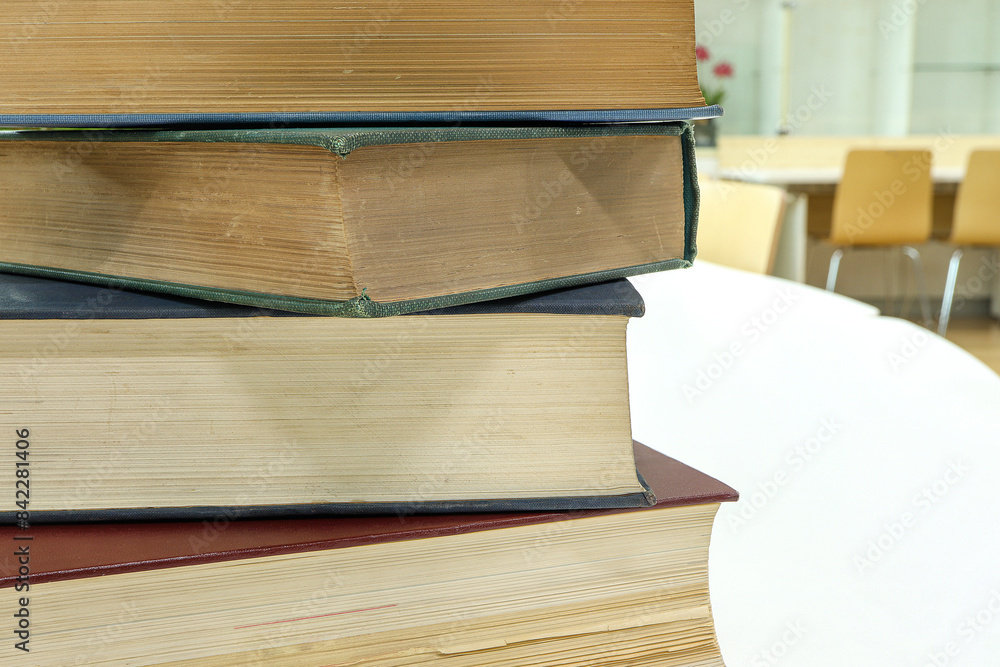 A stack of old books on table in library.Conceptual background on library, education A stack of old books on table in library.Conceptual background on library, education