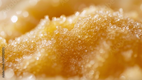 Close-up of a body scrub application, showcasing granulated sugar mix on glowing skin. photo