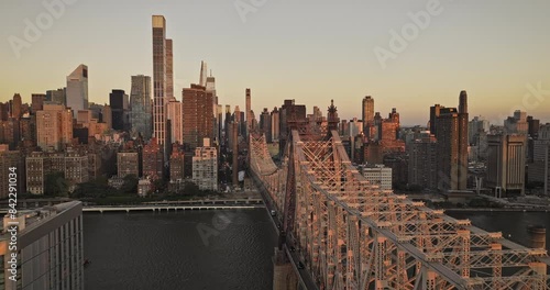 NYC New York Aerial v365 flyover Roosevelt Island along Queensboro Bridge capturing traffics crossing and sunrise glow over cityscape of Midtown Manhattan - Shot with Mavic 3 Pro Cine - September 2023 photo