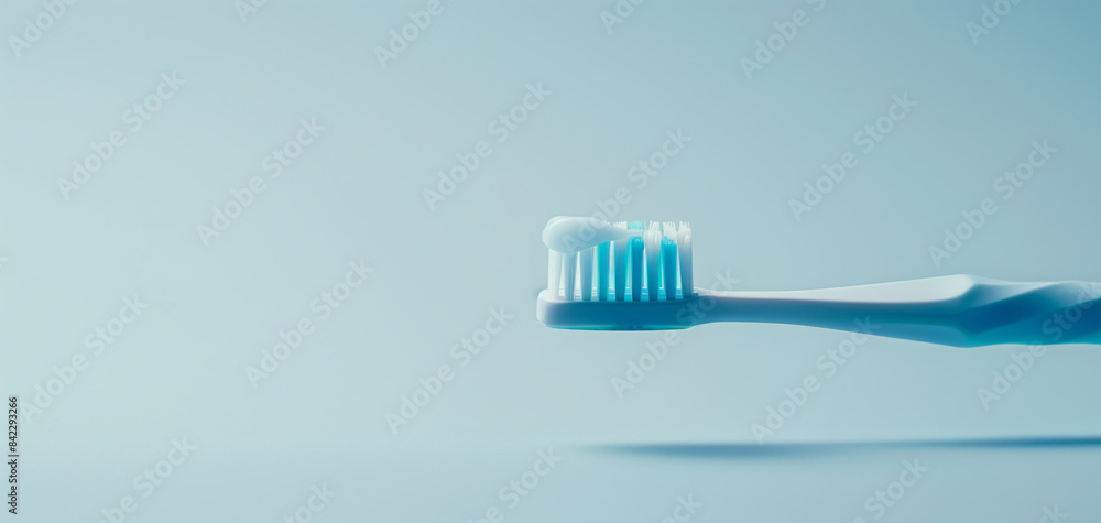 Close-up of a toothbrush with toothpaste against a light blue background. Ideal for dental hygiene and dental care-themed stock photos. Close-up of a toothbrush with toothpaste against a light blue background. Ideal for dental hygiene and dental care-themed stock photos.