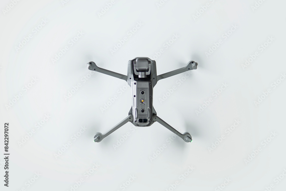 flying drone with spinning propellers on white background bottom view flying drone with spinning propellers on white background bottom view