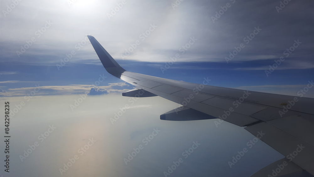 Fototapeta premium Aeroplane Wings Window View Blue Sky and Beautiful Clouds 7