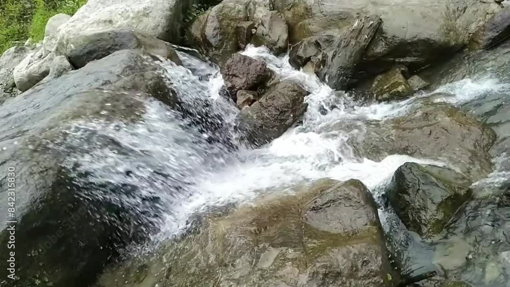 Clear river water flows over the rocks Clear river water flows over the rocks