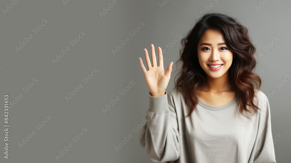 Chinese woman smiling in casual apparel with welcome gesture greeting isolated Chinese woman smiling in casual apparel with welcome gesture greeting isolated
