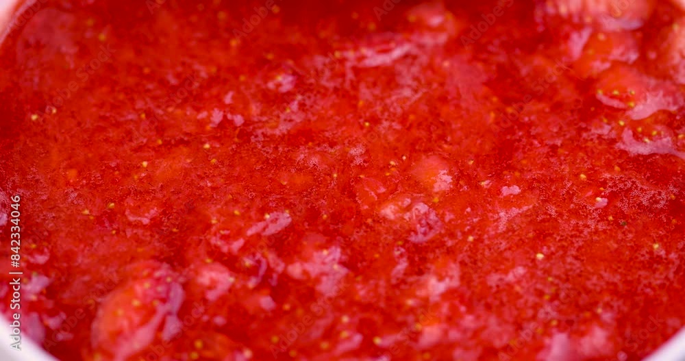 grated red ripe strawberries during cooking, juice and pieces of strawberries after pressing grated red ripe strawberries during cooking, juice and pieces of strawberries after pressing