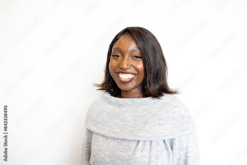 A confident woman is shown smiling in a grey sweater, suitable for professional headshots or corporate profiles A confident woman is shown smiling in a grey sweater, suitable for professional headshots or corporate profiles