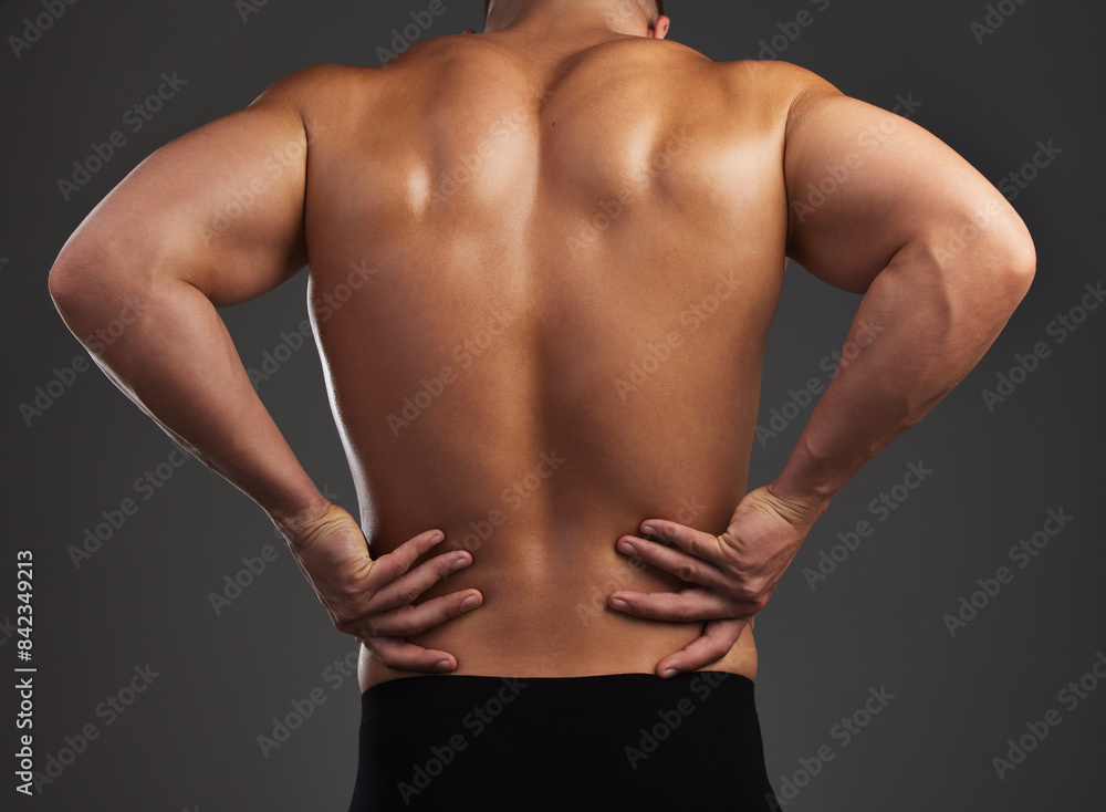 Back pain, stress and fitness man in studio with workout mistake, fail or muscle inflammation on black background. Sports, injury and bodybuilder with backache, spine or anatomy, risk and emergency Back pain, stress and fitness man in studio with workout mistake, fail or muscle inflammation on black background. Sports, injury and bodybuilder with backache, spine or anatomy, risk and emergency