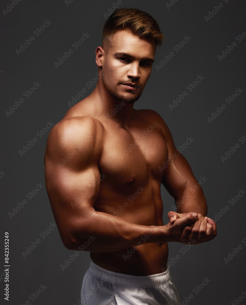 Portrait, flexing and bodybuilder in studio for exercise, training and fitness for health. Sportsman, athlete and shirtless for wellness by dark background for transformation, workout and pose Portrait, flexing and bodybuilder in studio for exercise, training and fitness for health. Sportsman, athlete and shirtless for wellness by dark background for transformation, workout and pose