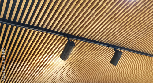 Modern lamella ceiling and black lamps.