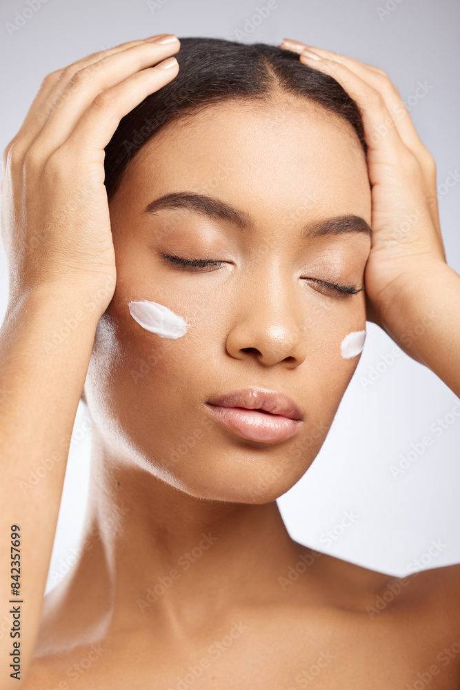 Naklejka premium Calm, face and woman with sunscreen for skincare and dermatology in studio background. Model, relax and girl with moisturizer lotion on skin for healthy glow or cream for natural beauty and cosmetics
