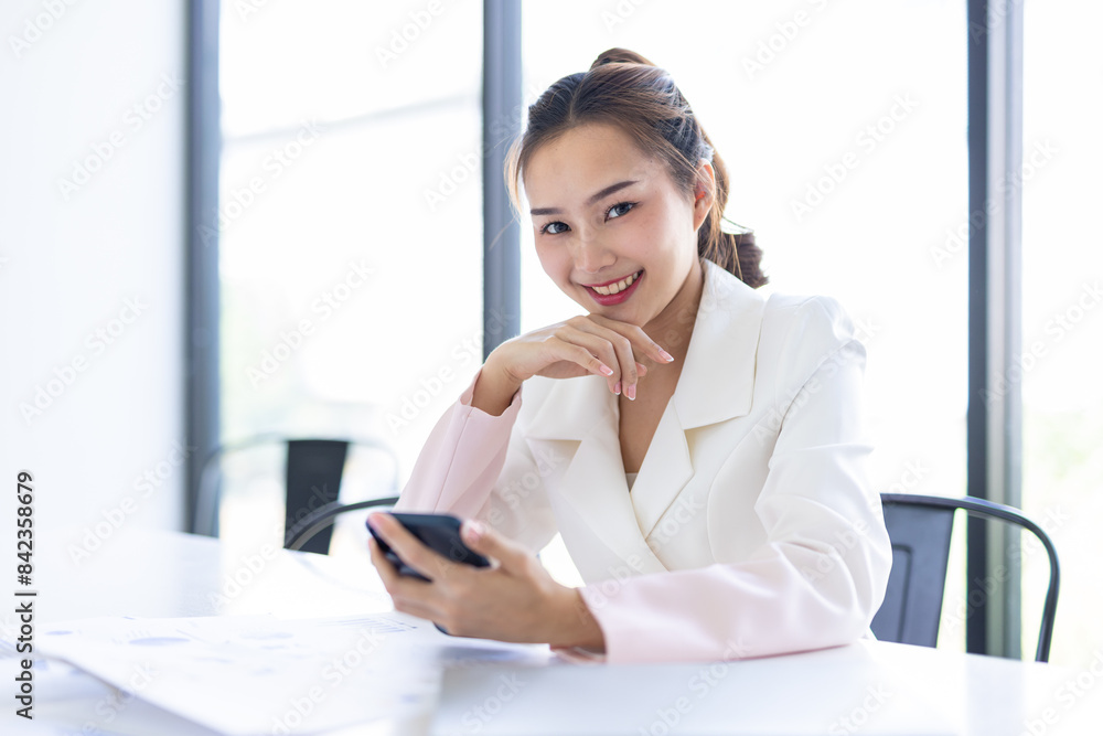 Asian Businesswoman Using laptop computer and working at office with calculator document on desk, doing planning analyzing the financial report, business plan investment, finance analysis concept.
Asian Businesswoman Using laptop computer and working at office with calculator document on desk, doing planning analyzing the financial report, business plan investment, finance analysis concept.