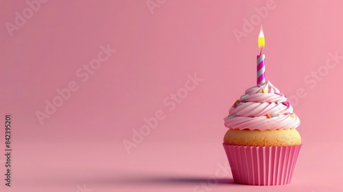 Birthday cupcake on solid background with copy space for text. Cupcake with a lit candle concept for birthday celebration or greeting card