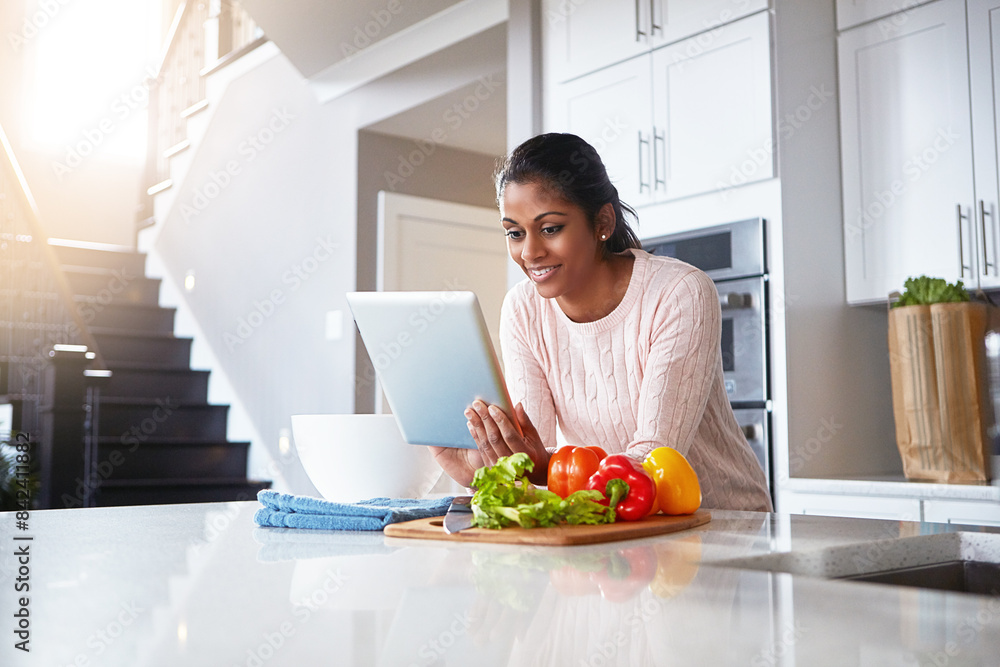 Tablet, ingredients and woman in kitchen for cooking with health, wellness and diet recipe. Smile, vegetables and Indian female person with digital technology for nutrition meal instructions at home. Tablet, ingredients and woman in kitchen for cooking with health, wellness and diet recipe. Smile, vegetables and Indian female person with digital technology for nutrition meal instructions at home.