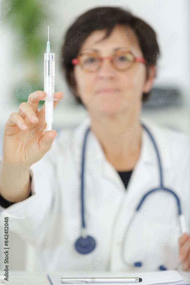 female doctor holds an injection female doctor holds an injection