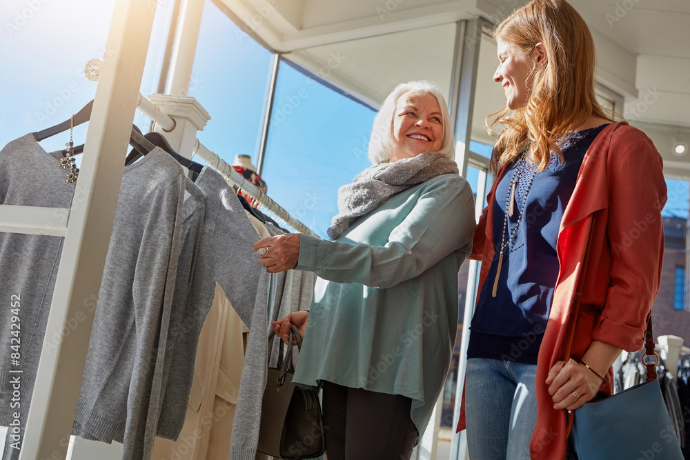 Mature woman, family and shopping for retail clothes of choice, decision and fashion sale for luxury wardrobe at boutique. Smile, mother and customer, designer product for quality fabric industry Mature woman, family and shopping for retail clothes of choice, decision and fashion sale for luxury wardrobe at boutique. Smile, mother and customer, designer product for quality fabric industry