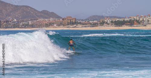 Canvas Print in the waves of the capes, in the background the hotel zone during the summer vacation season, with visitors from all over the world