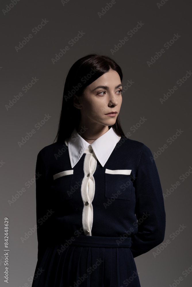 Portrait of attractive caucasian young brunette woman in school uniform in studio. Elegant woman posing. Pretty stylish model. Beauty, Style, Fashion, Luxury Portrait of attractive caucasian young brunette woman in school uniform in studio. Elegant woman posing. Pretty stylish model. Beauty, Style, Fashion, Luxury