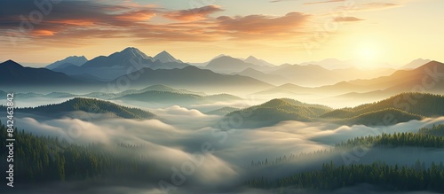 Wallpaper Mural A stunning aerial view of a mountain peak surrounded by clouds at sunrise in summer, showcasing a beautiful landscape with rocky terrain, dense forests, and a cloudy sky, ideal for a copy space image. Torontodigital.ca