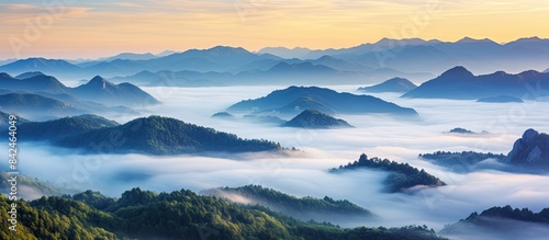 Scenic mountain landscape draped in morning mist; ideal for a copy space image.