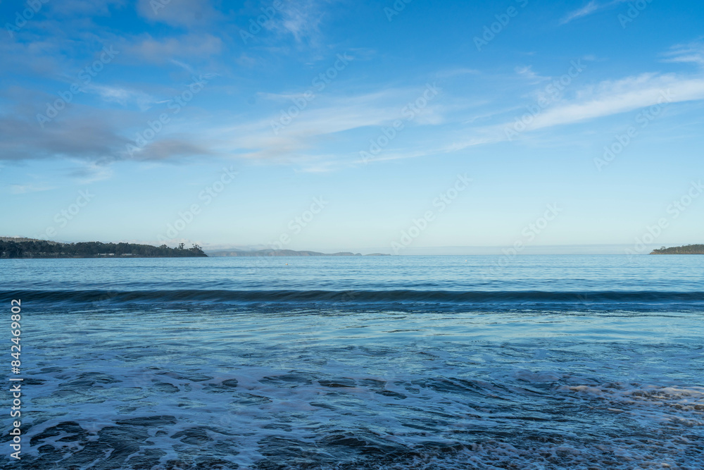 beautiful waves rolling in on a sandy beach in winter in Tasmania Australia beautiful waves rolling in on a sandy beach in winter in Tasmania Australia