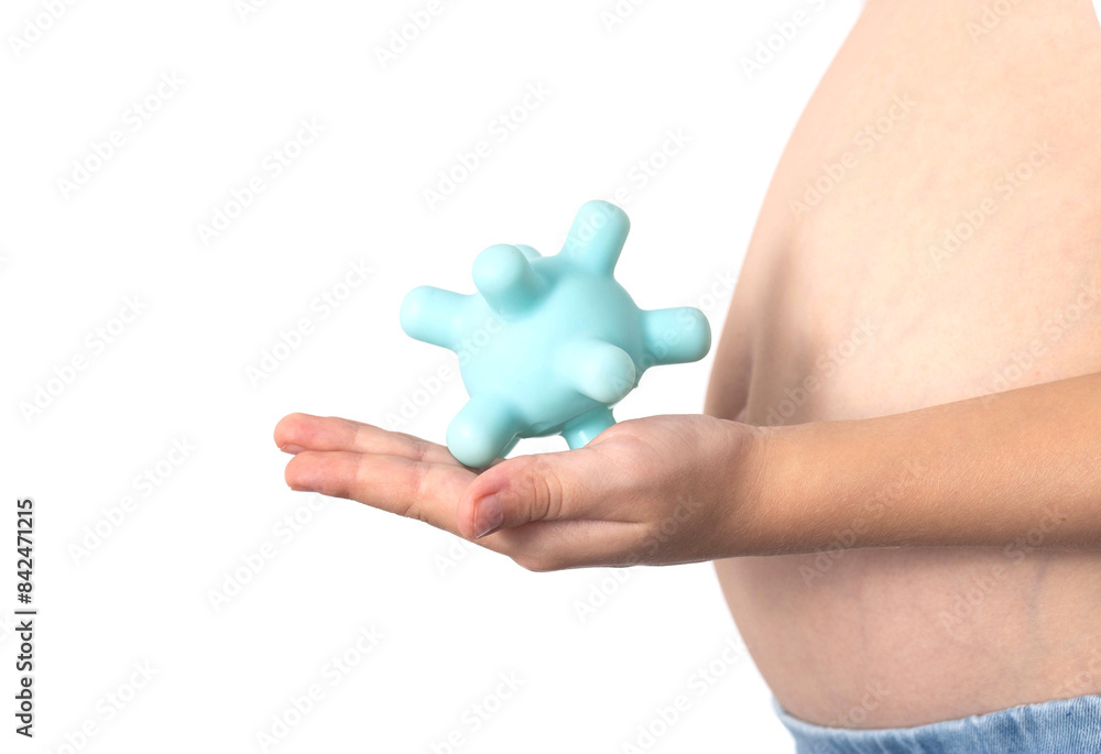 The girl holds a model of the virus against the background of her stomach. Concept of viral intestinal infections in children. Rotovirus infection, close-up The girl holds a model of the virus against the background of her stomach. Concept of viral intestinal infections in children. Rotovirus infection, close-up