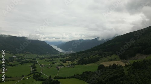 Aerial Upwards Panning Shot Showing the Scenic Landscape of Vikøyri, Vik i Sogn, in Norway. With many clouds in the sky photo