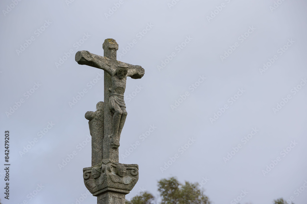 Christian cross on stone monument against cloudy sky, detailed carvings and weathered texture. Religious symbol outdoor backdrop. Saint Roque Lookout. Christian cross on stone monument against cloudy sky, detailed carvings and weathered texture. Religious symbol outdoor backdrop. Saint Roque Lookout.