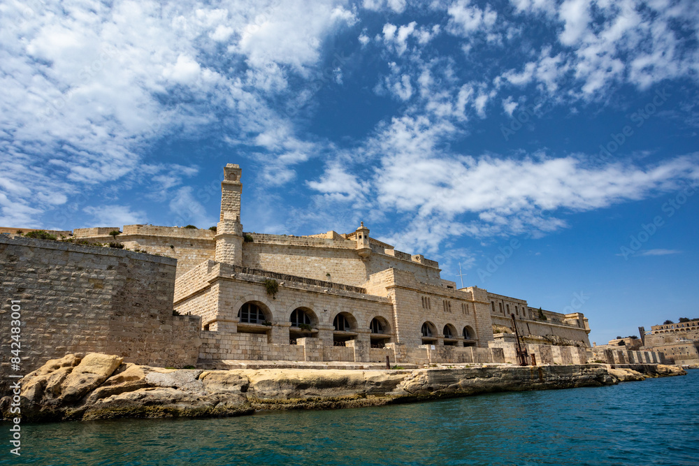 Fototapeta premium Fort St. Angelo, symbol of Malta's resilience, majestic stone walls, silent witness to rich history. Port in Birgu. Malta