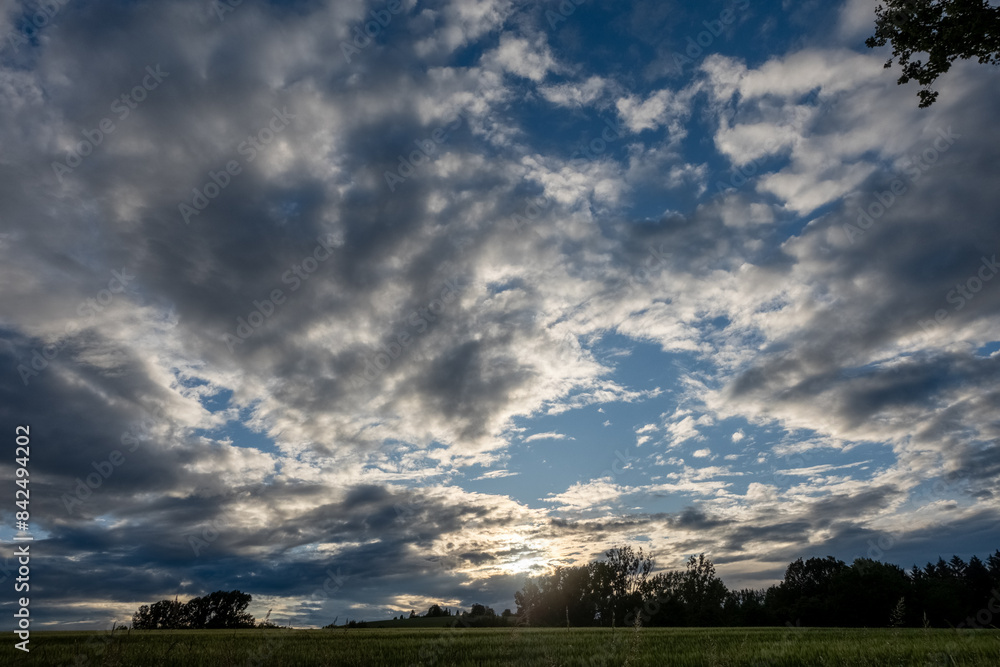 Cloudy sky at sunset, sunlight behind the clouds Cloudy sky at sunset, sunlight behind the clouds